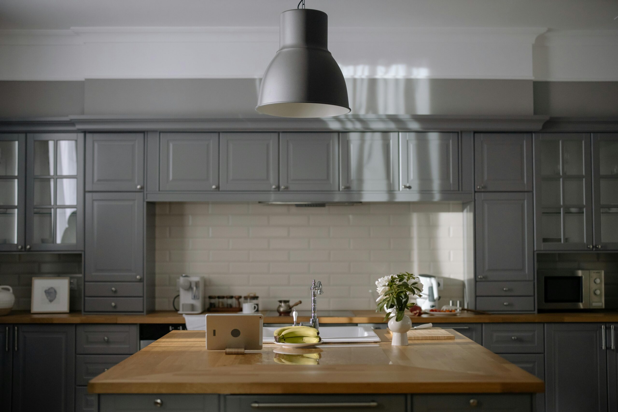 pexels-cottonbro-6938705 a modern kitchen with a wooden island