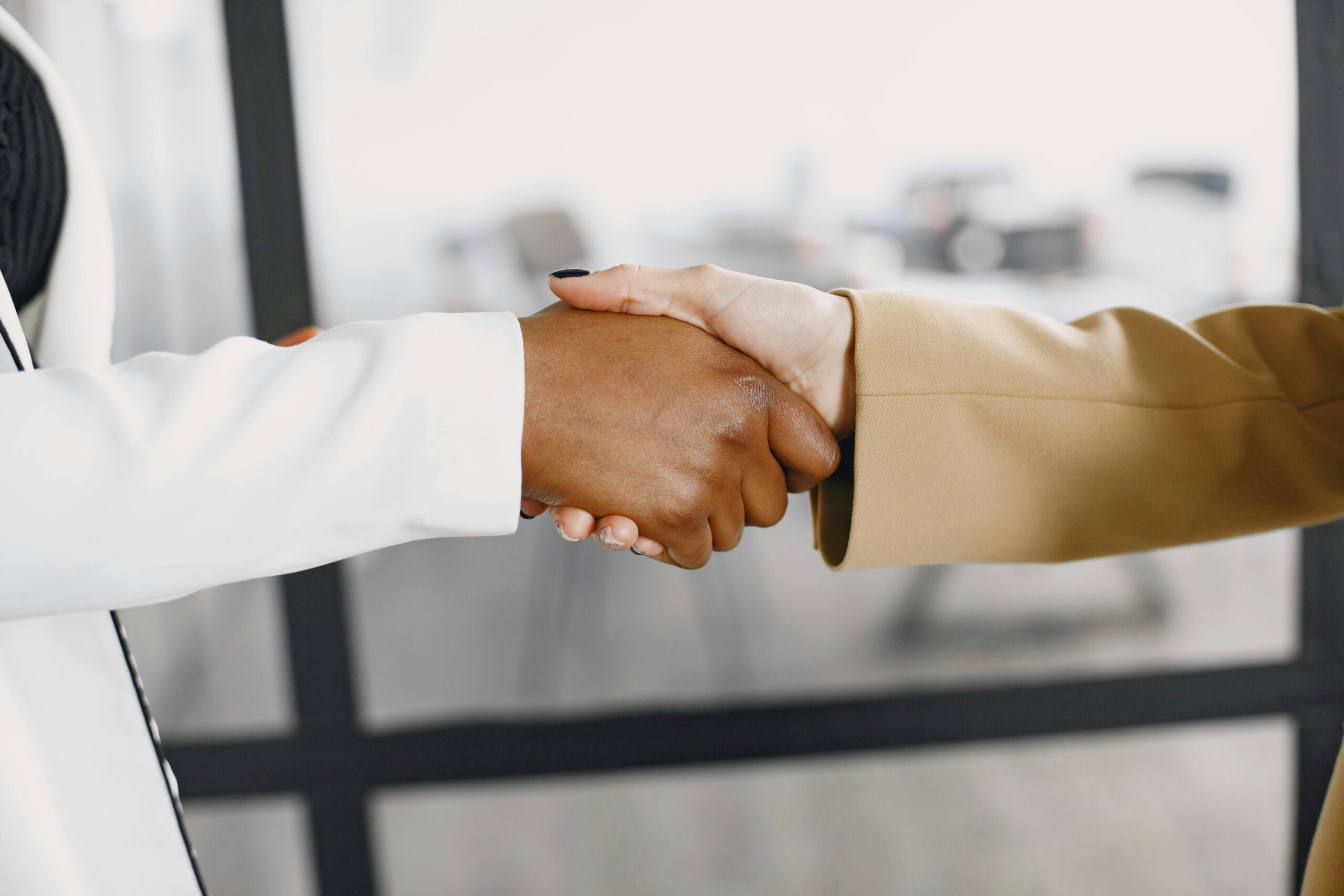two people in suits shaking hands
