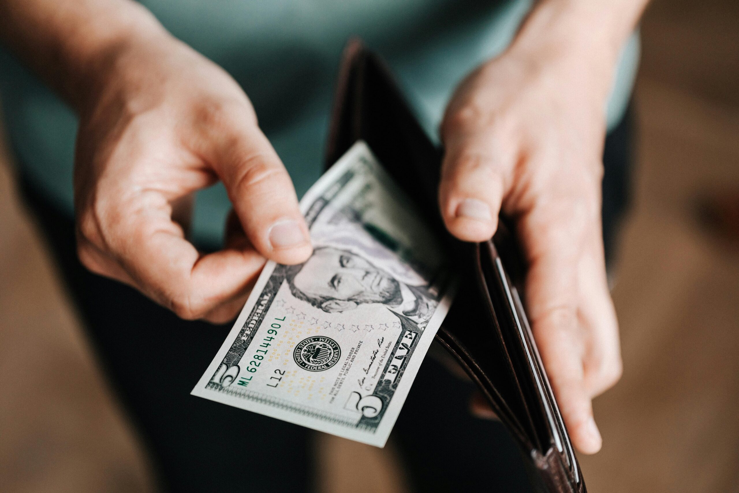 someone taking cash out of a wallet
