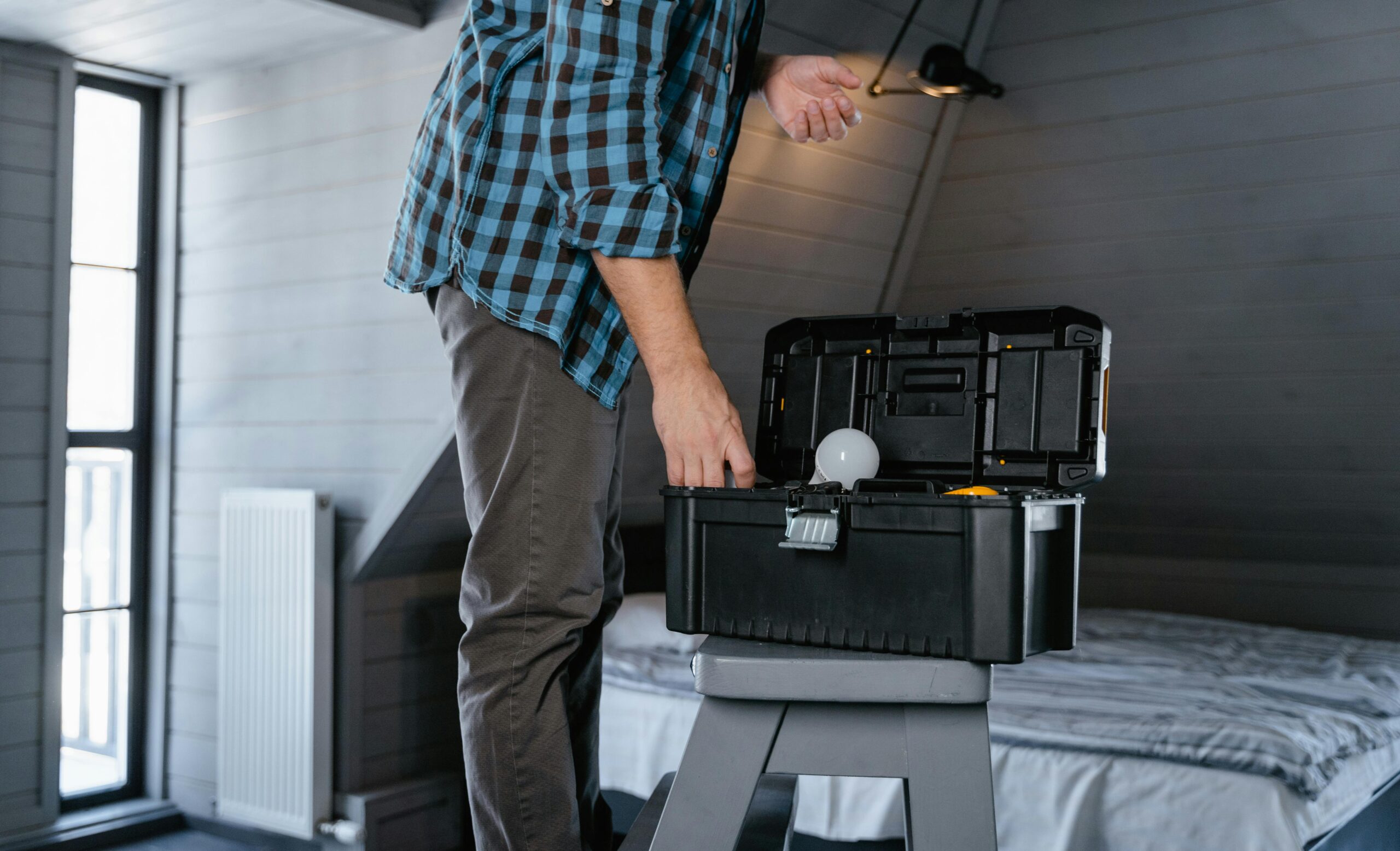 someone on a stepstool changing a lightbulb