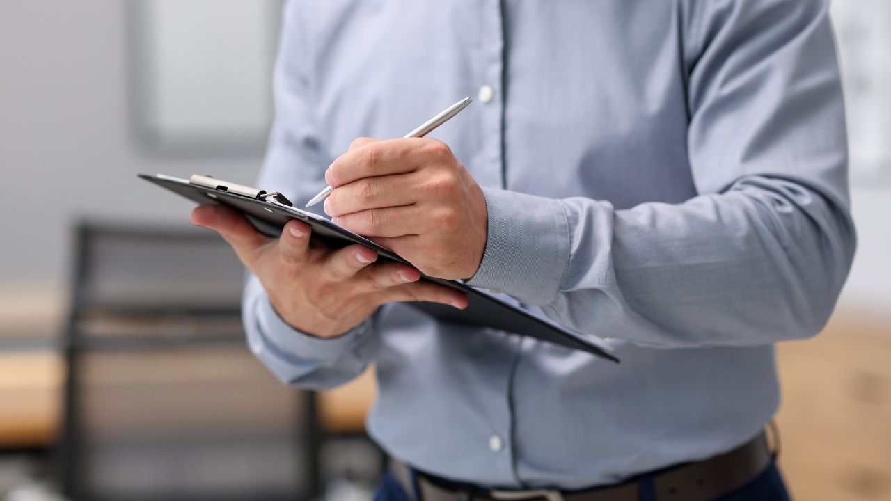 Landlord completing rental property inspection checklist