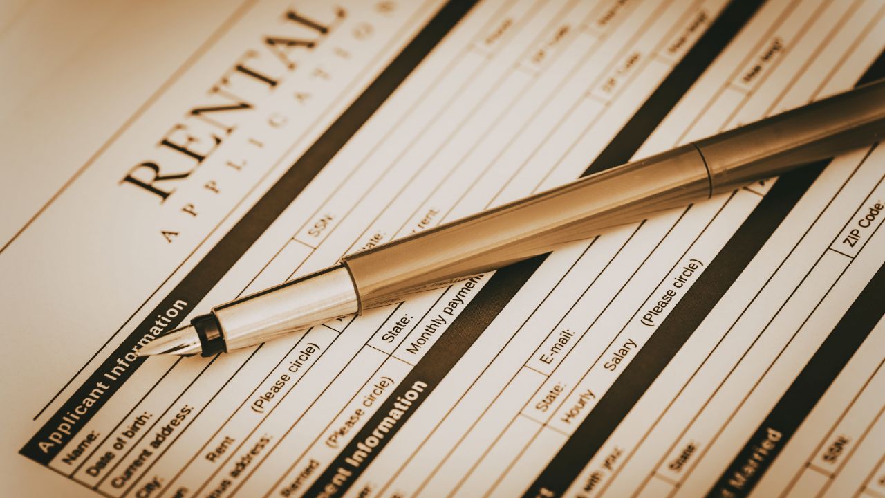 Rental application form on desk with pen